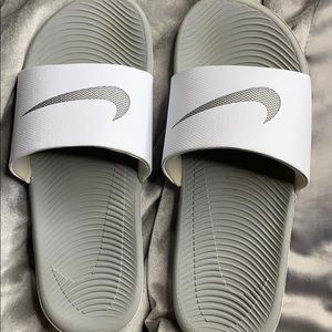 Grey and white nike slides